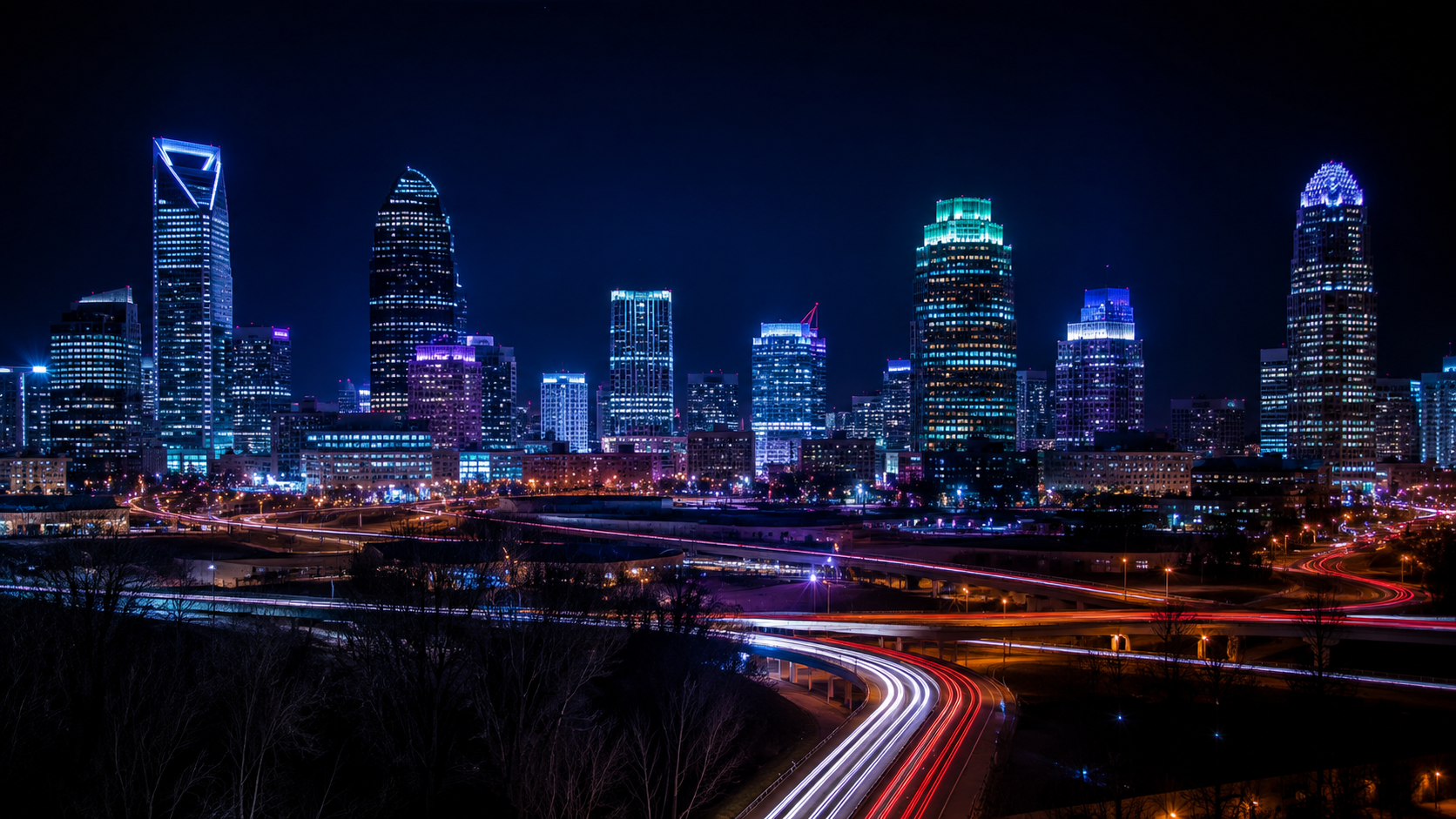 Long exposure photograph of Charlotte, North Carolina at night with light trails from moving traffic